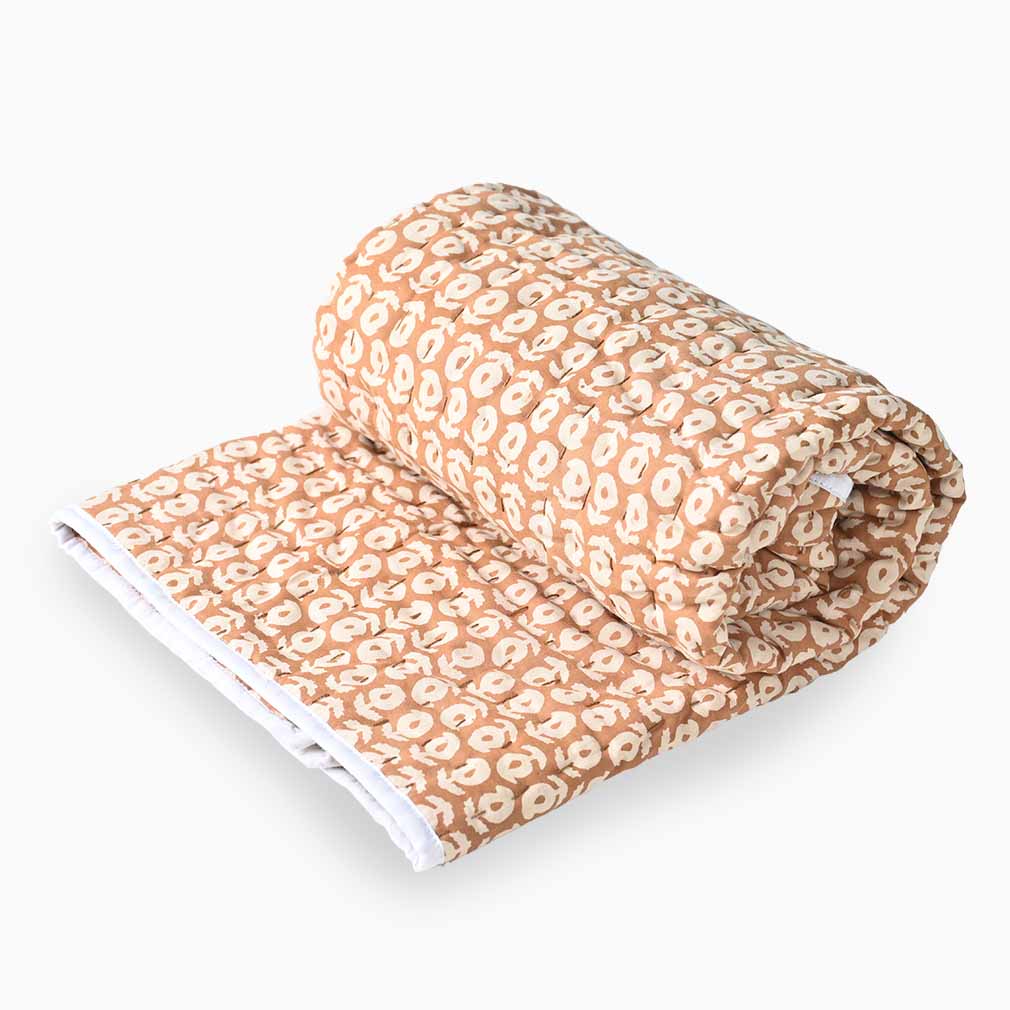 Folded blanket with a pattern on a white background