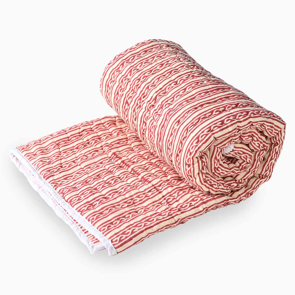 Rolled-up fabric with red and white pattern on a white background