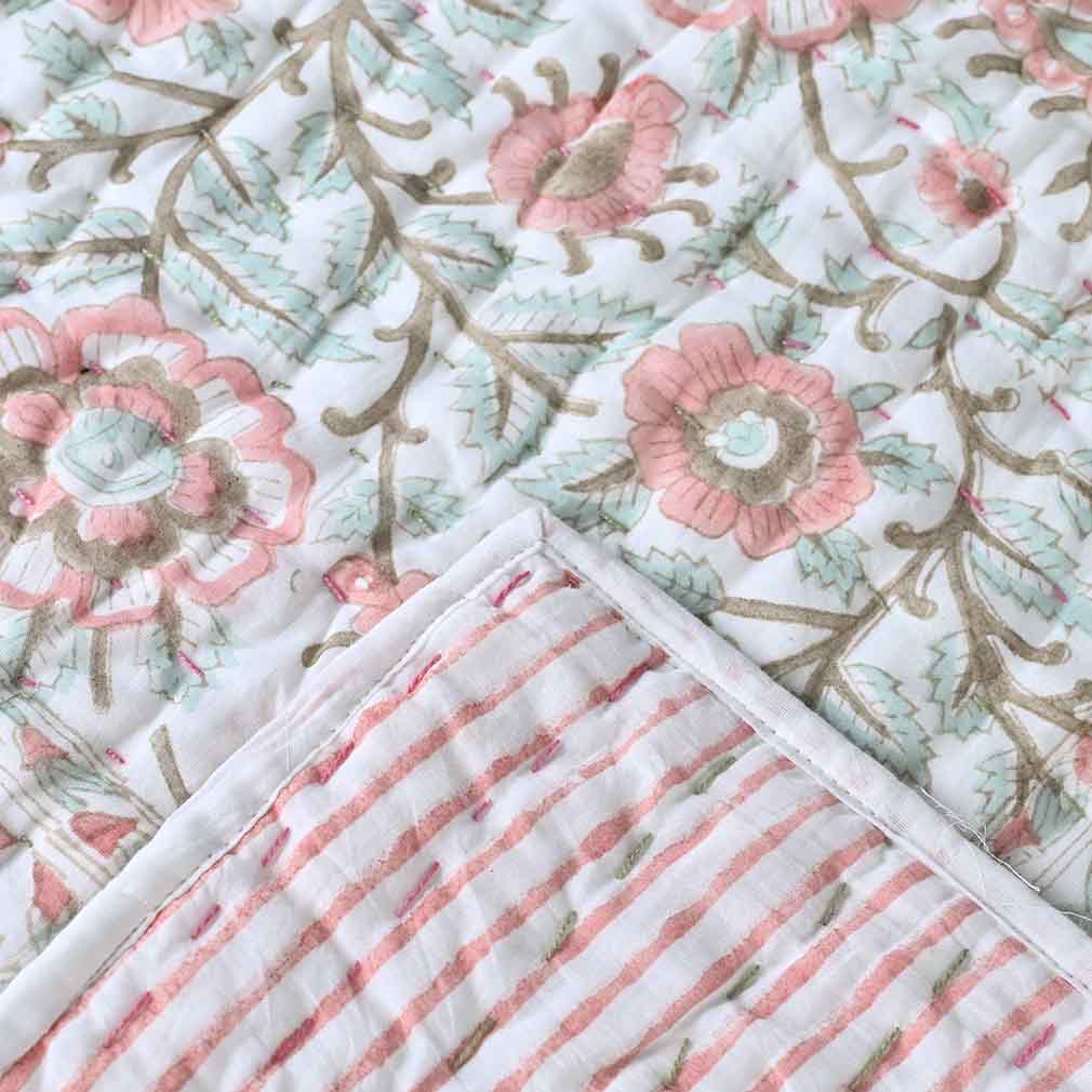 Close-up of floral and striped hand made kantha quilt