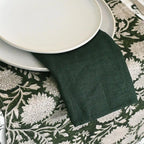Green linen napkins styled on a dining table