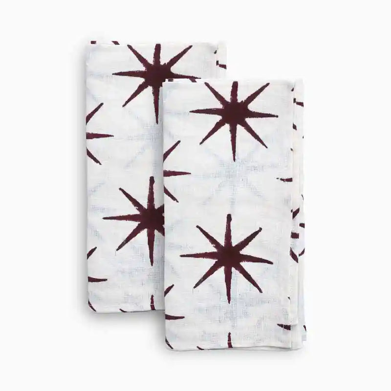 Cotton block print napkins with deep red star motif on white fabric

