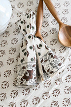 Hand block printed cotton napkins in brown styled on a dining table