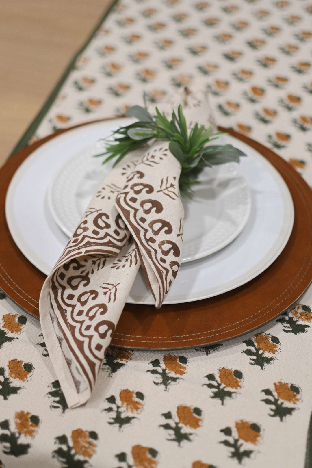 Hand block printed cotton napkins in brown styled on a dining table