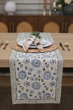 Close‑up of rust floral buti block print on cotton napkin put on a dining table