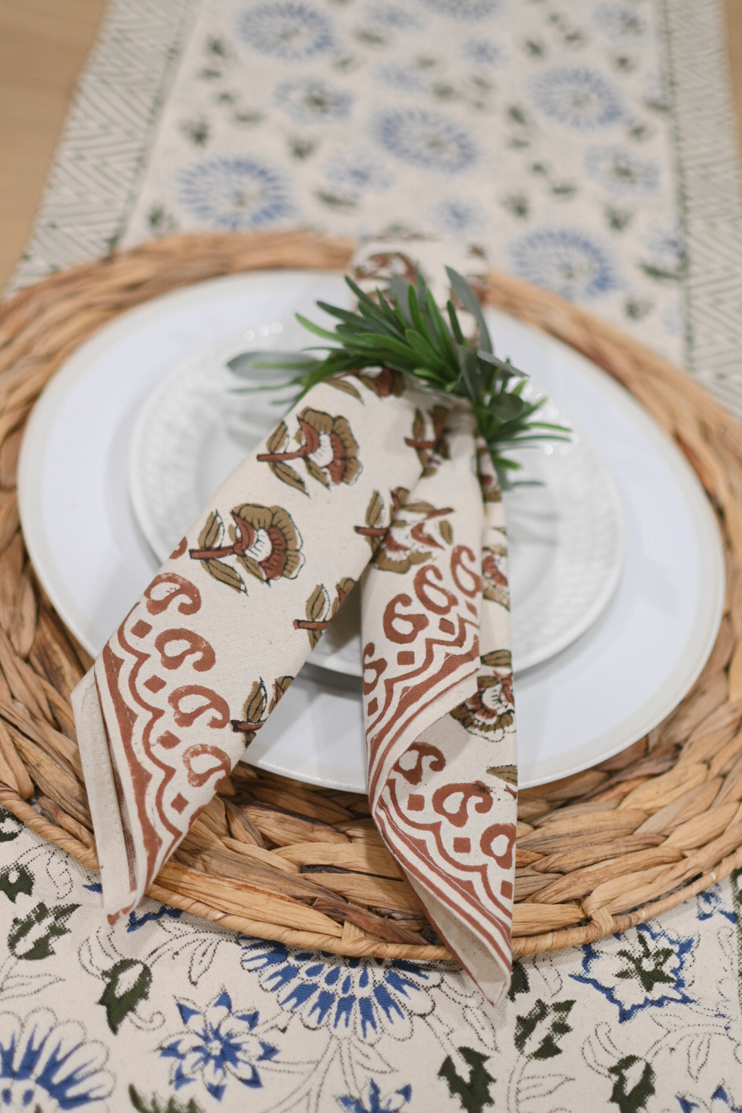 Hand block printed cotton napkins in rust styled on a dining table