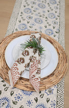 Close‑up of rust floral buti block print on cotton napkin