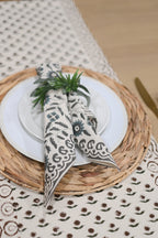 Close‑up of rosewood floral buti block print on cotton‑linen table runner