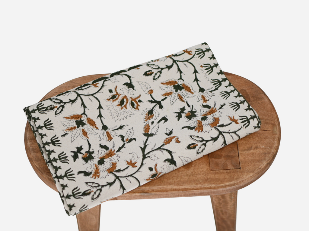 Close‑up of amber gold floral block print on cotton‑linen table runner