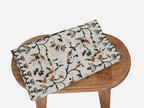 Close‑up of amber gold floral block print on cotton‑linen table runner