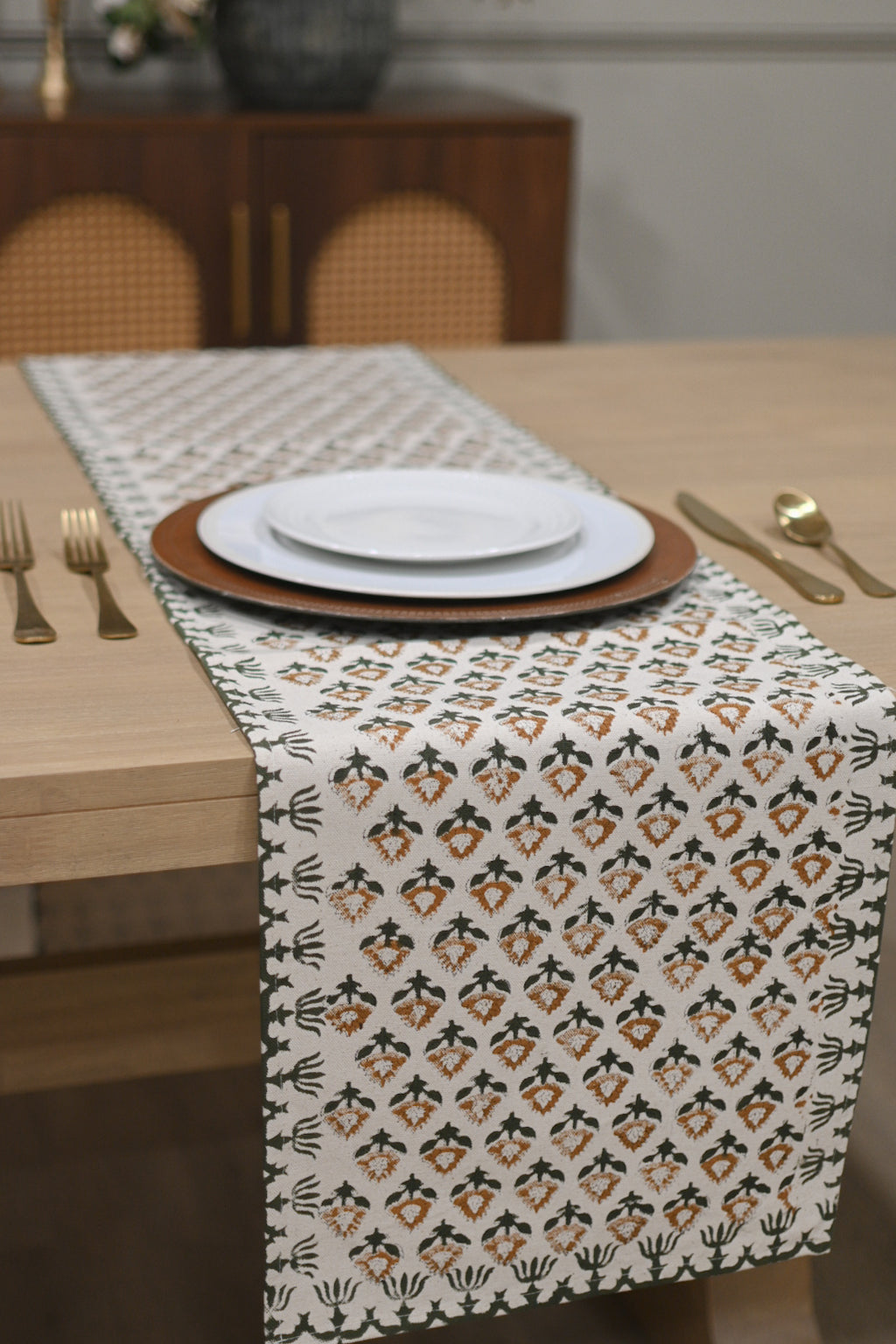 White and brown block printed table runner styled on a dining table
