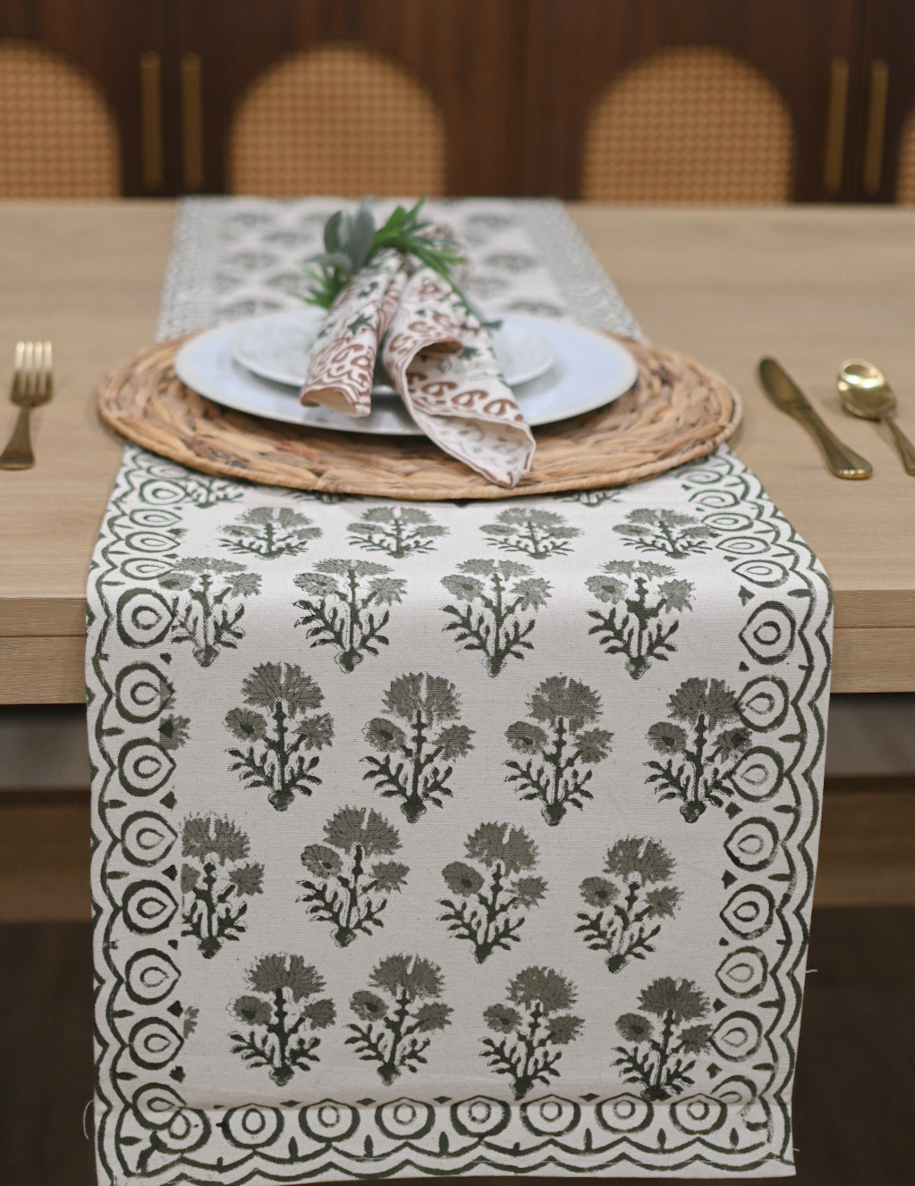 White and sage green block printed table runner styled on a dining table