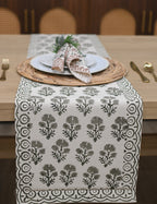 White and sage green block printed table runner styled on a dining table
