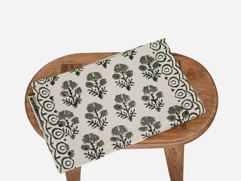 Close‑up of sage green floral buti block print on cotton‑linen table runner