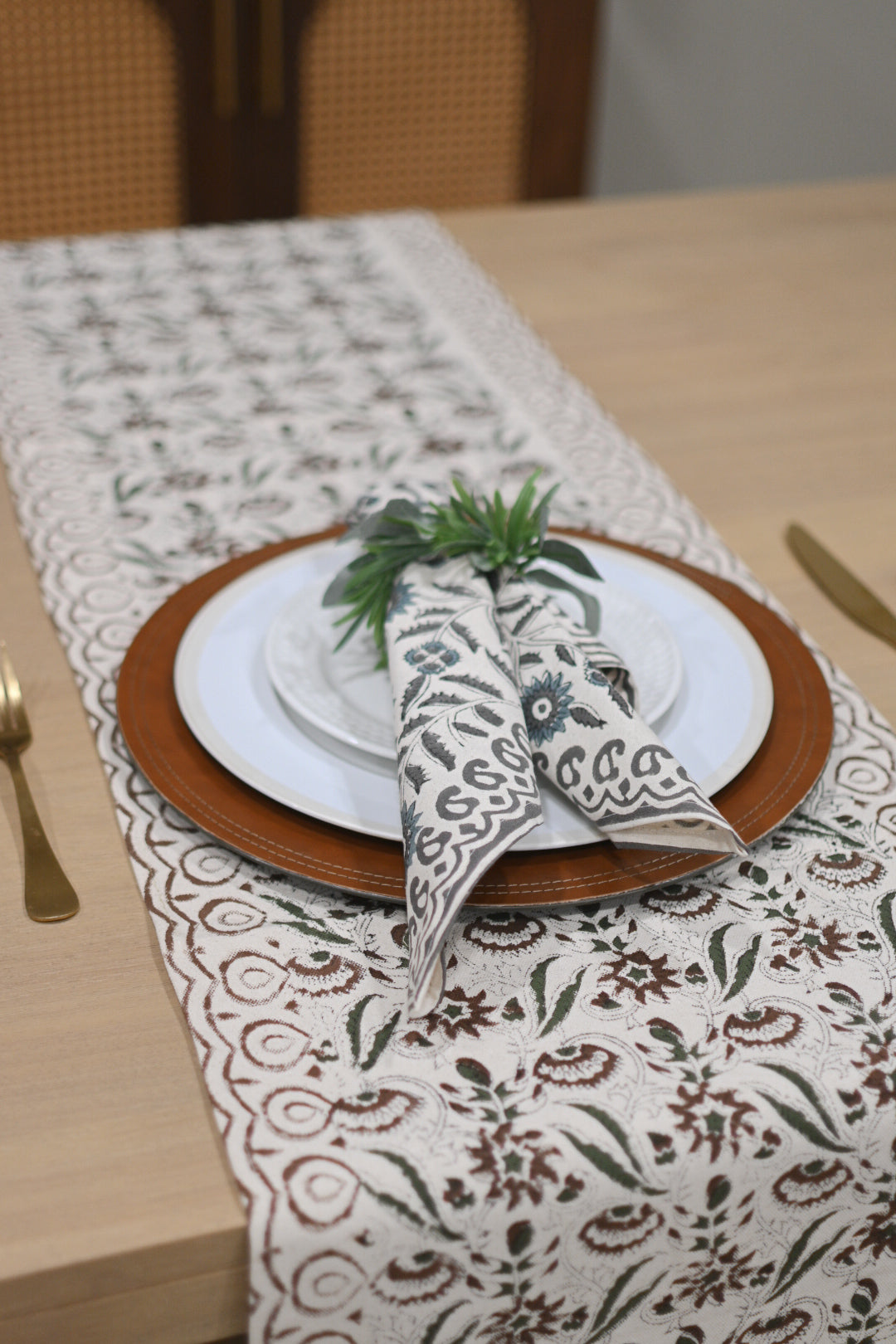 White table runner with rust brown and warm gray block print styled on a dining table
