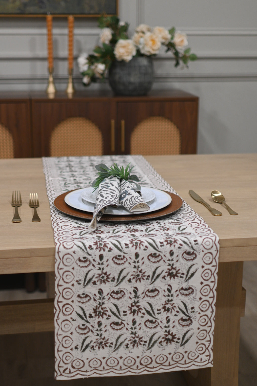 Close‑up of rust brown floral block print on cotton‑linen table runner