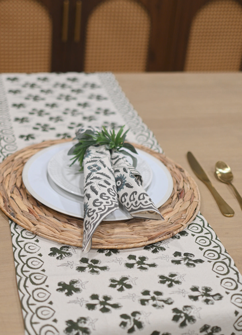 White and olive green block printed table runner styled on a dining table