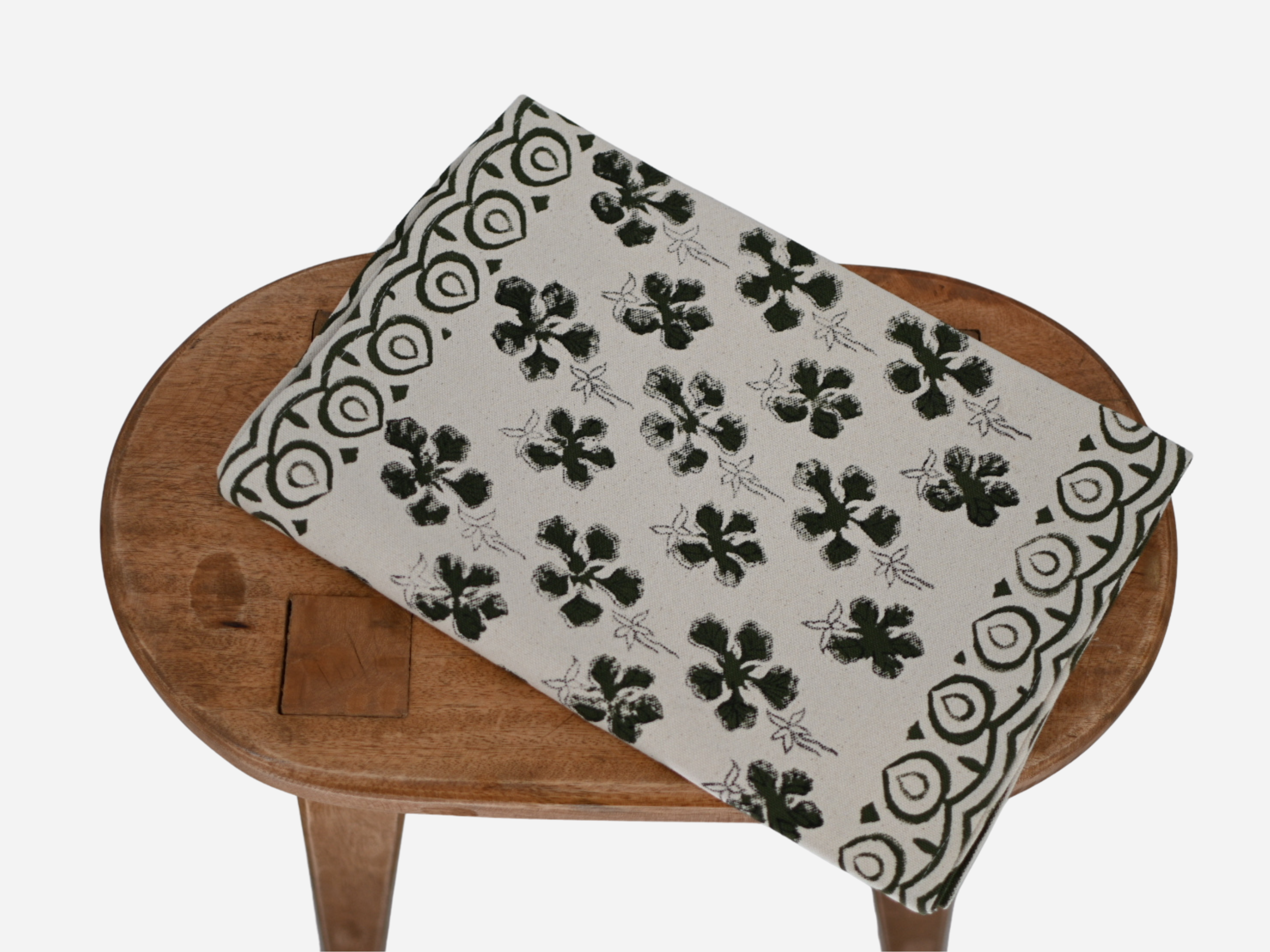 Close‑up of olive green floral buti block print on cotton‑linen table runner