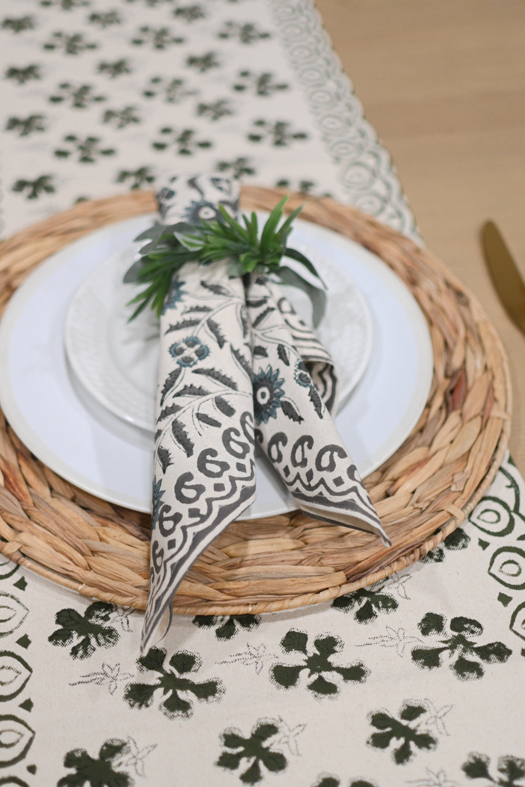 Close‑up of olive green floral buti block print on cotton‑linen table runner