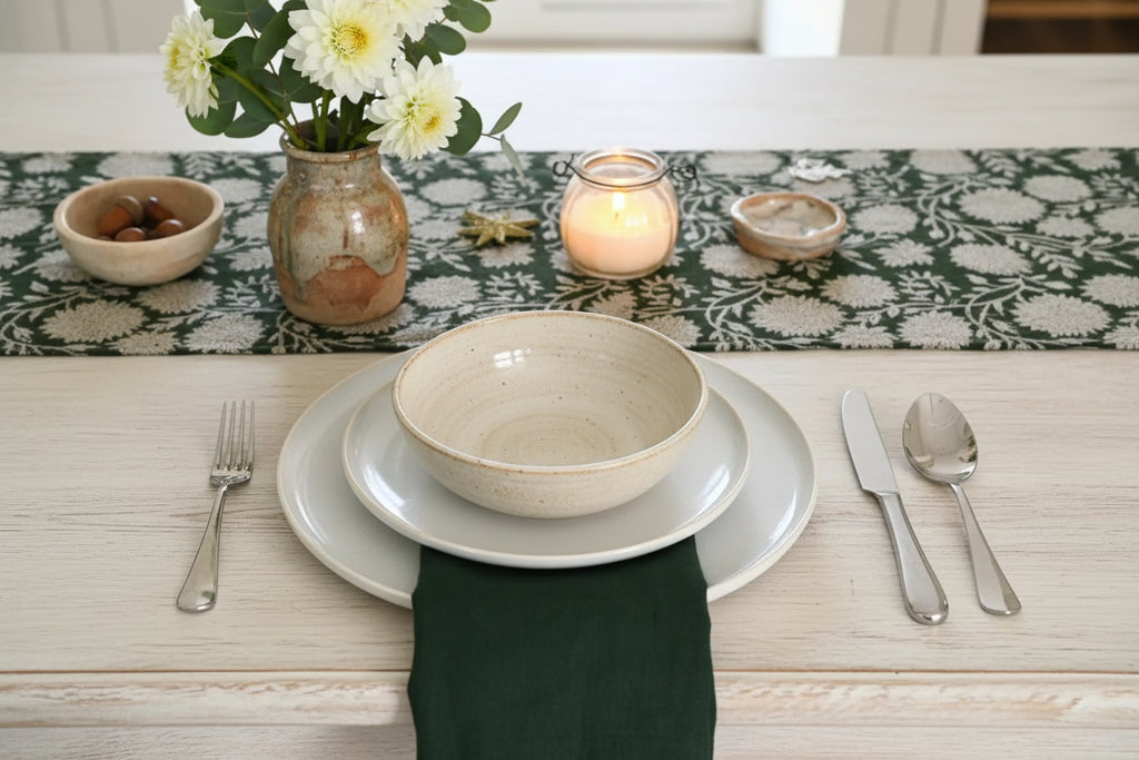 Olive green and oat block print table runner styled on a dining table