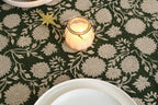 Close‑up of floral block print pattern on olive green table runner