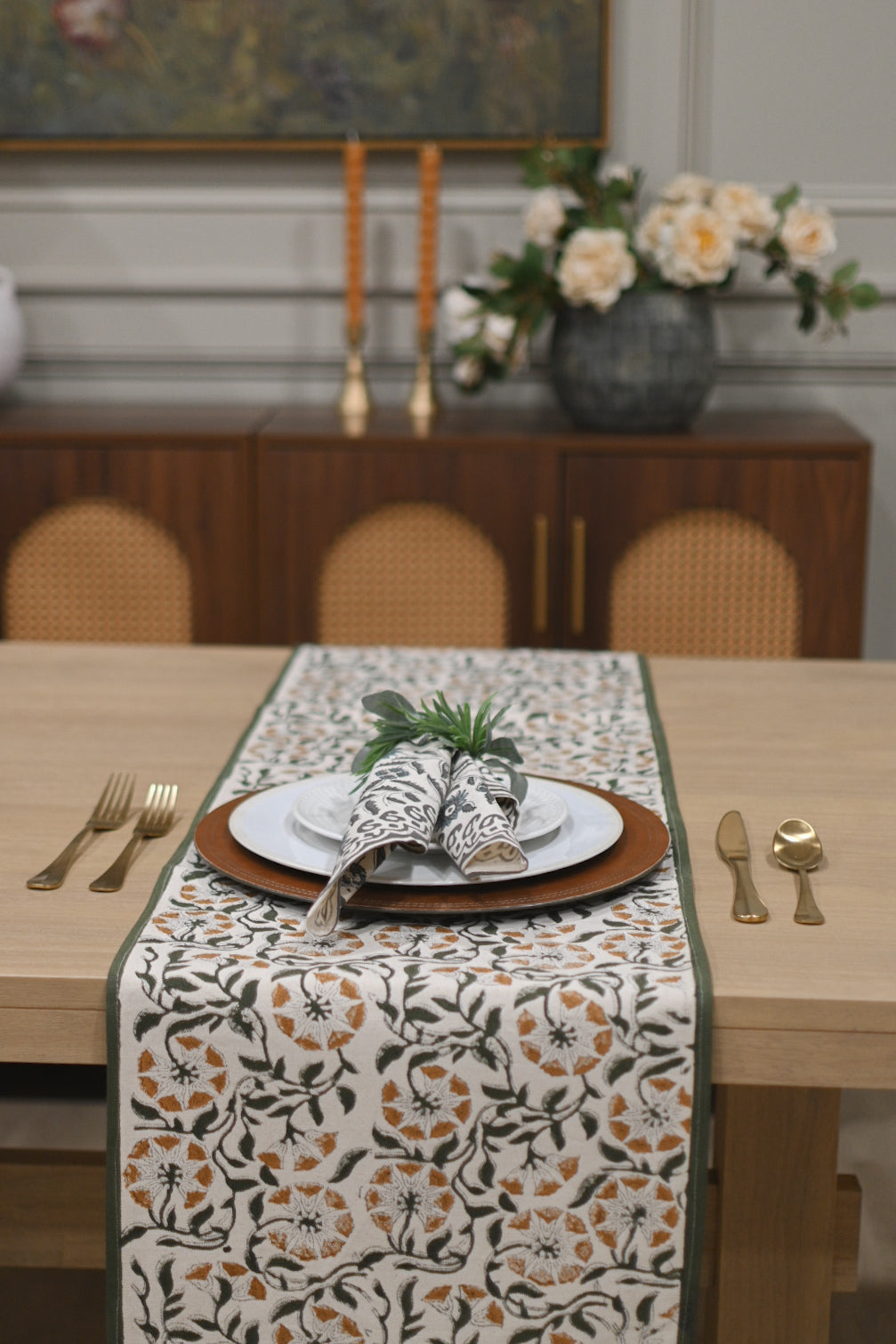 White table runner with fern green and fog gray block print styled on a dining table