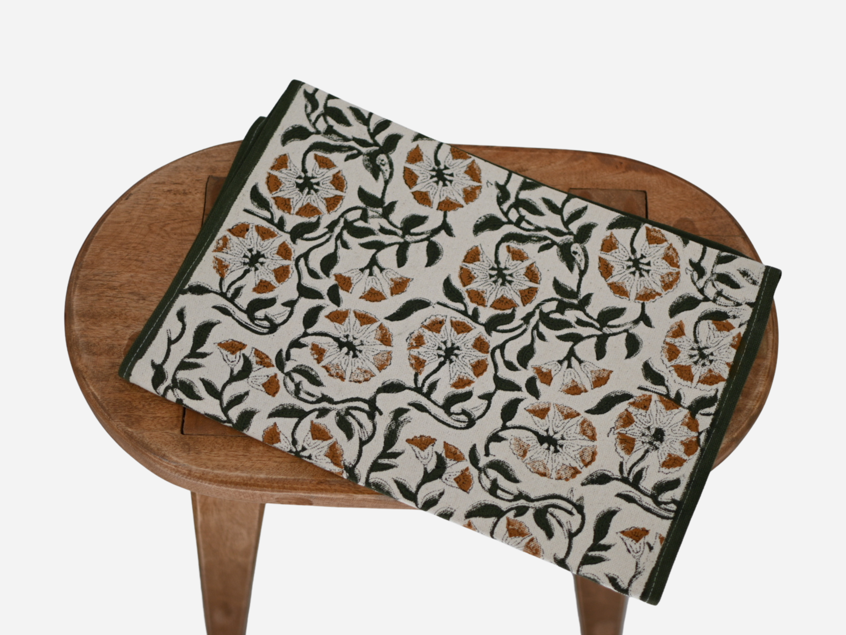 Close‑up of green and gray floral block print on cotton‑linen table runner