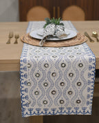 White table runner with fern green and oxford blue block print styled on a dining table
