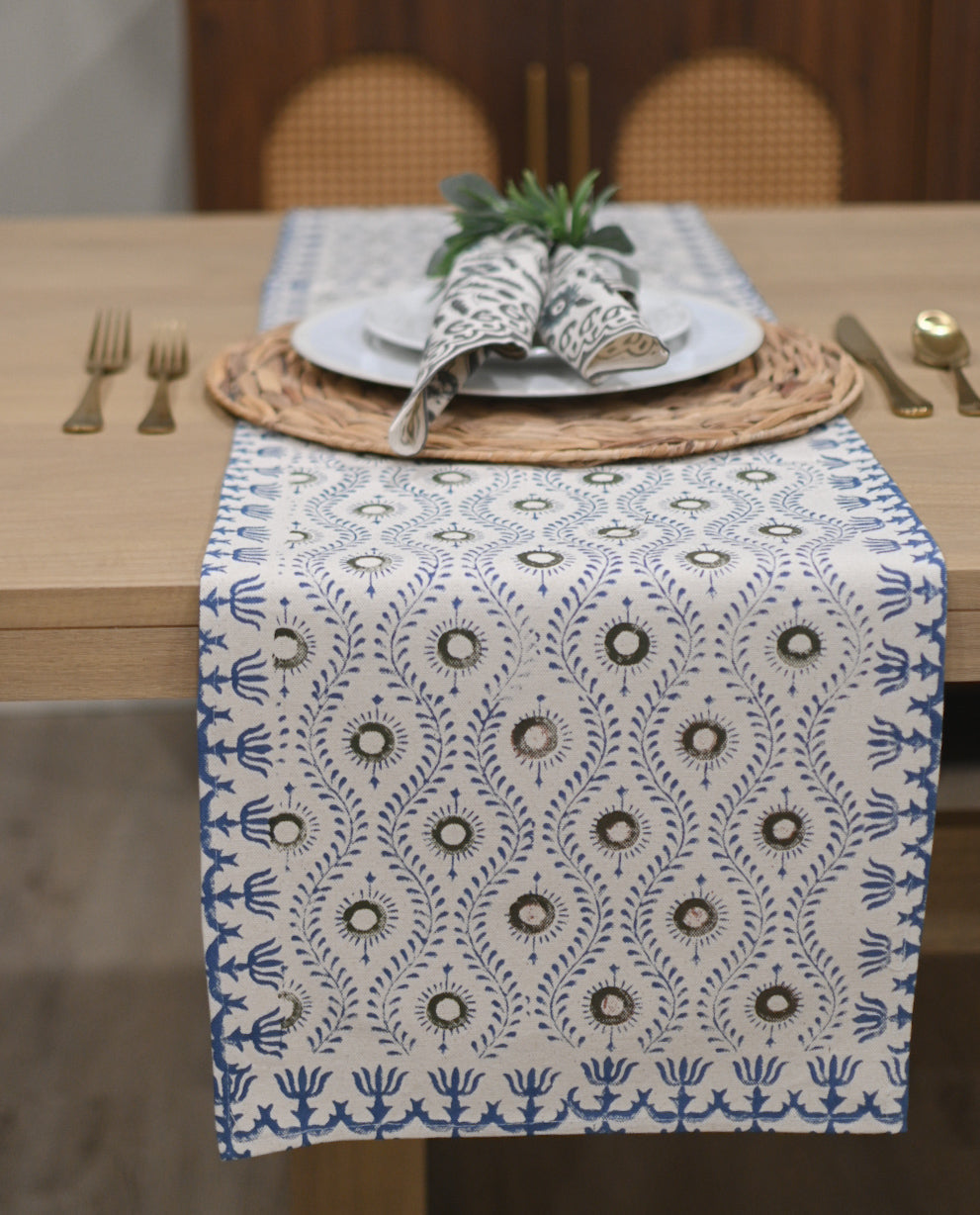 White table runner with fern green and oxford blue block print styled on a dining table