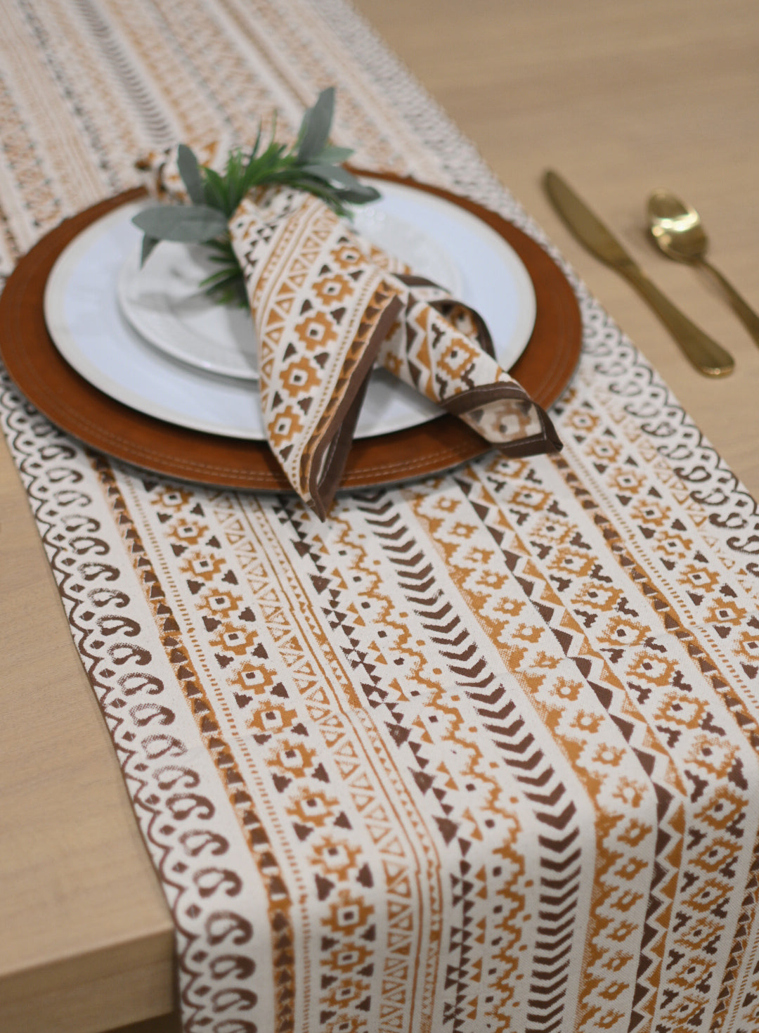 Close‑up of gold mustard geometric block print on cotton‑linen table runner