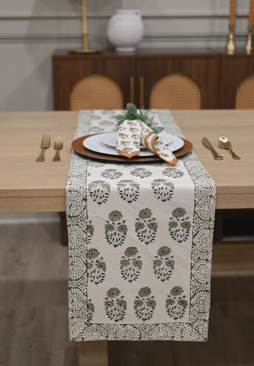 White and sage green block printed table runner styled on a dining table