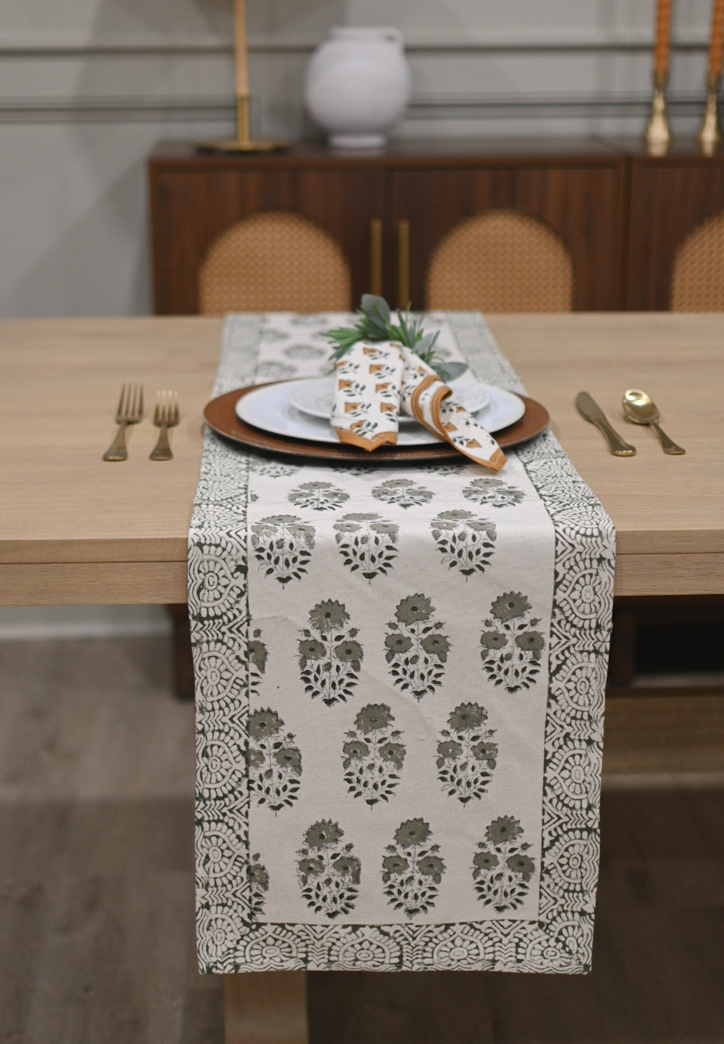 White and sage green block printed table runner styled on a dining table