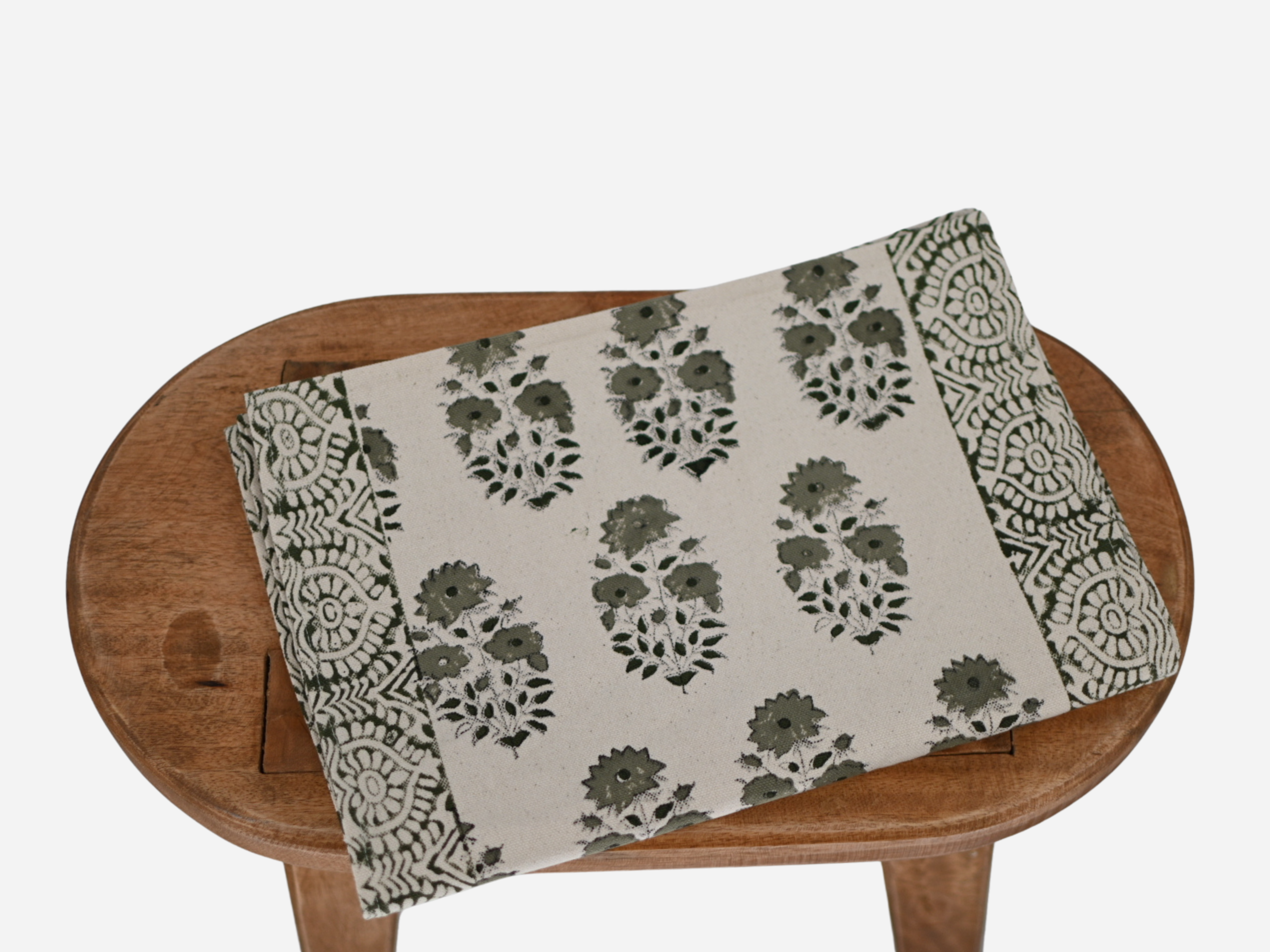 Close‑up of sage green floral buti block print on cotton‑linen table runner