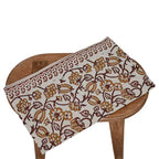 Off white and amber gold block printed table runner styled on a dining table