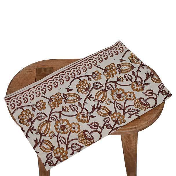 Off white and amber gold block printed table runner styled on a dining table