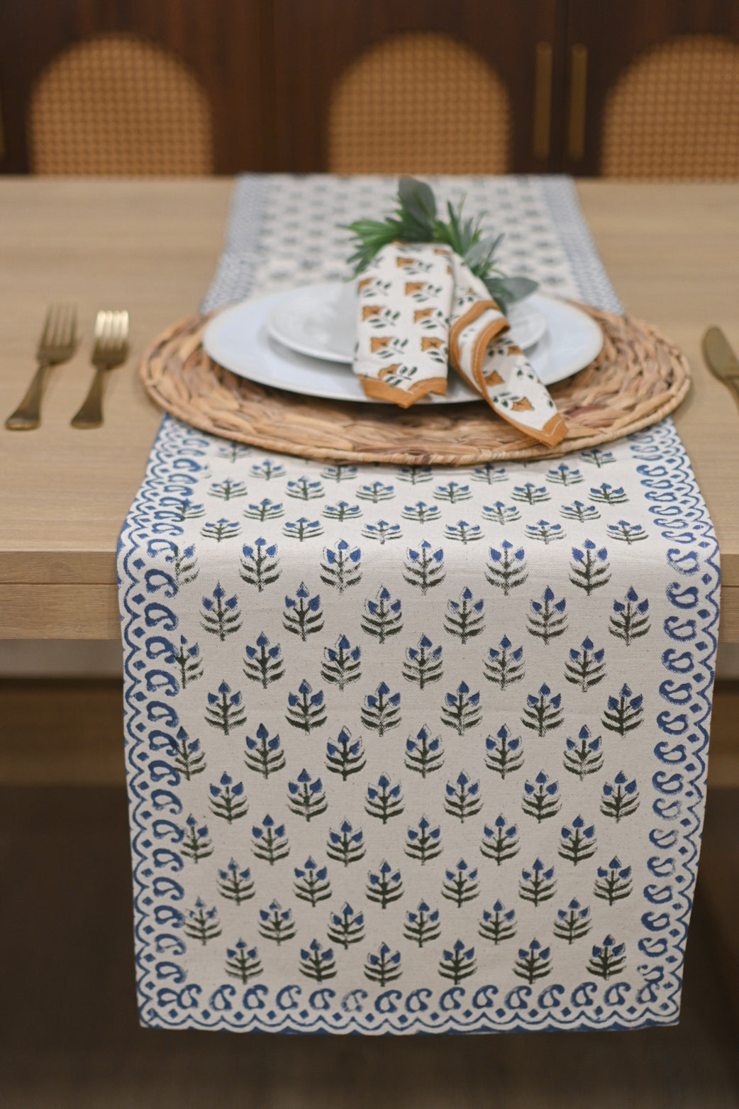 White and blue block printed table runner styled on a dining table