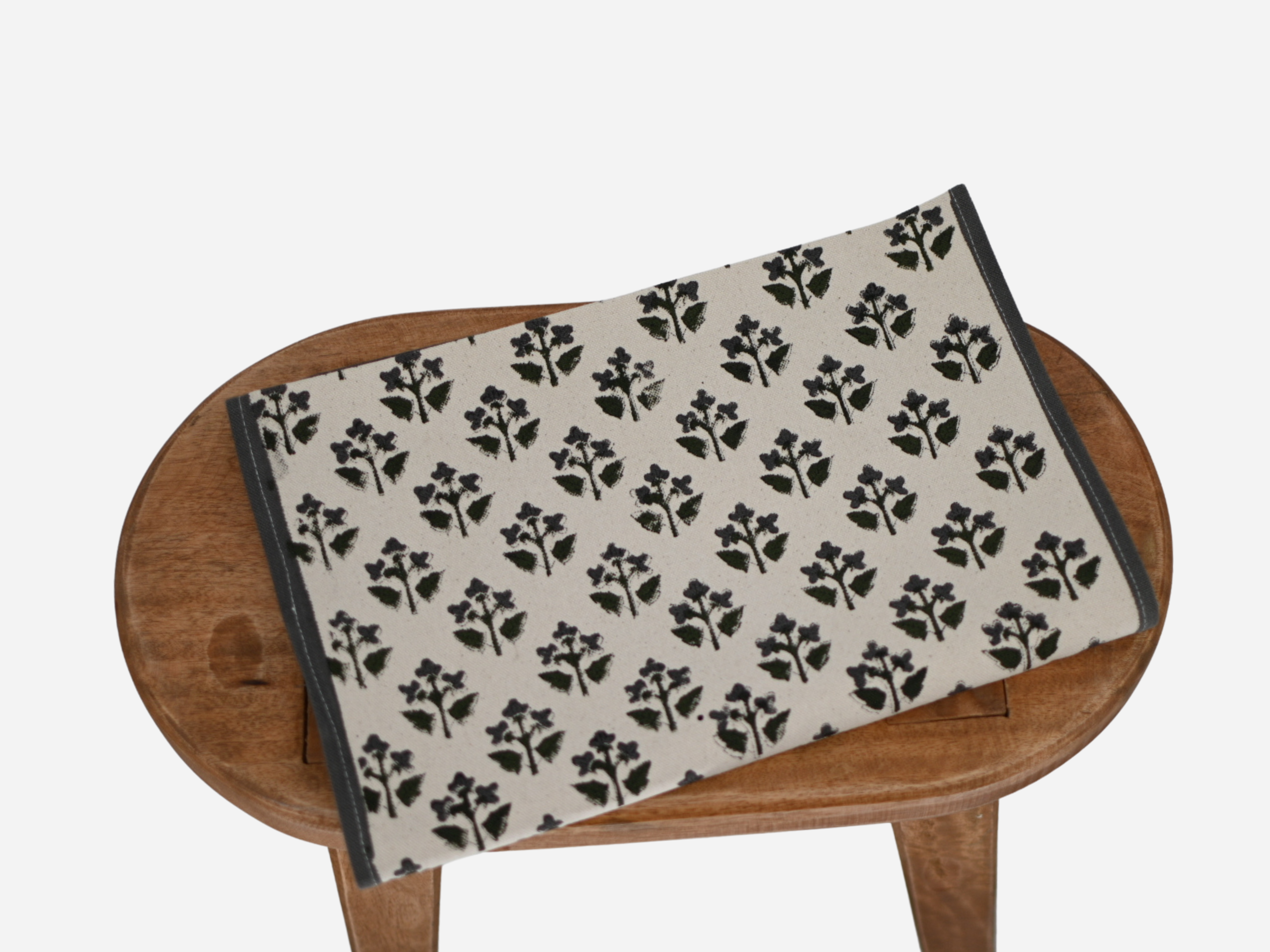 Close‑up of black floral buti block print on cotton‑linen table runner
