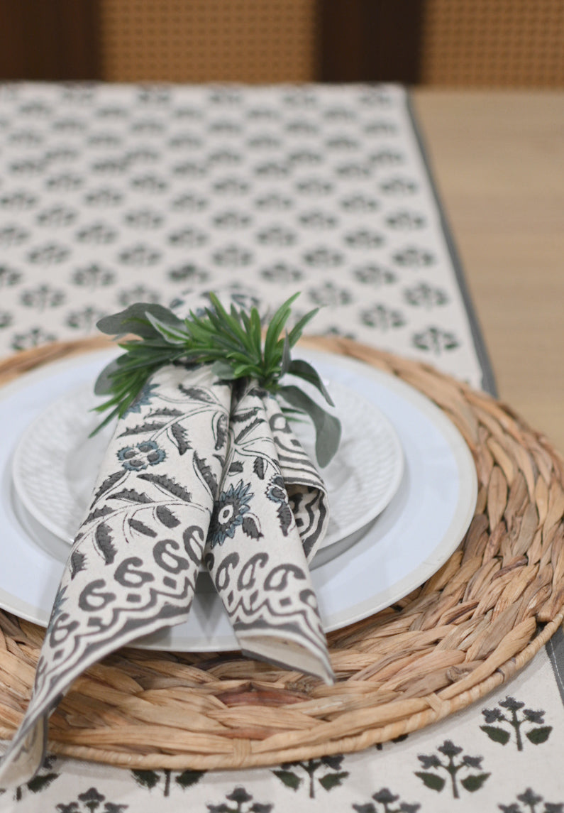 Close‑up of black floral buti block print on cotton‑linen table runner