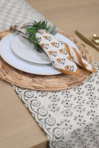 Close‑up of black abstract floral block print on cotton‑linen table runner