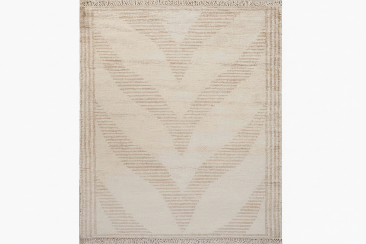 Beige area rug with geometric pattern on a white background